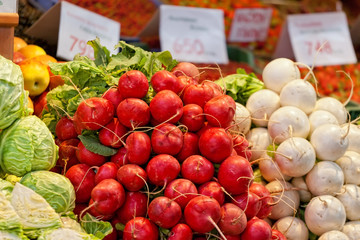 Garden radish and other vegetables on a counter in the market
