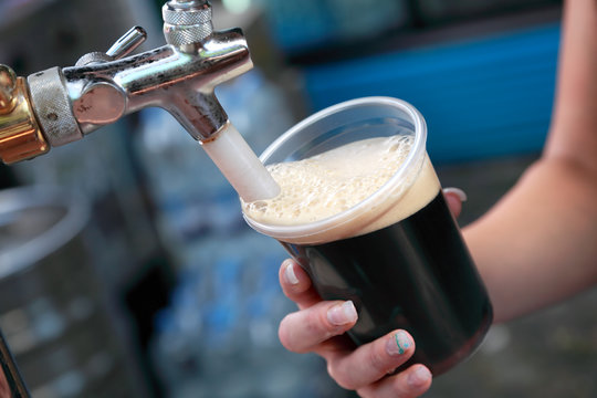 Beer Festival Pouring Dark Beer To Glass