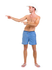Man on vacation man in shorts pointing on copy space