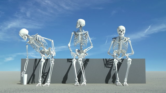 Three skeletons sitting down watching something,