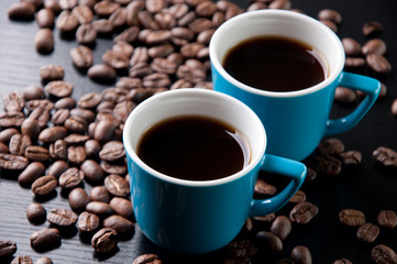 Horizontal shot of espresso and roasted coffee beans, close-up