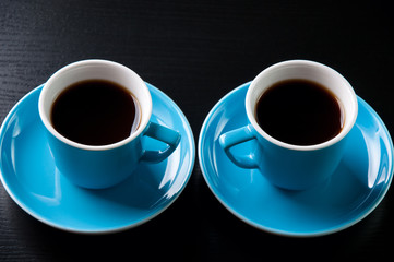 Two espresso cups on a wooden table