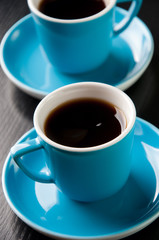 Close-up shot of two espresso cups on a wooden table