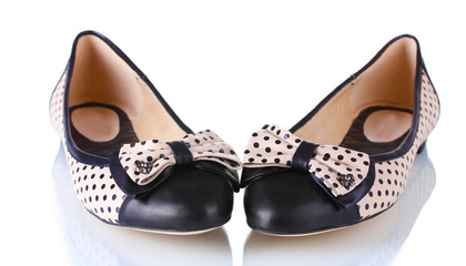 Female flat ballet shoes patterned with black polka dots