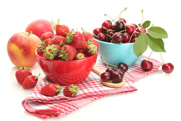 Ripe strawberries and cherry berries in bowls isolated on white