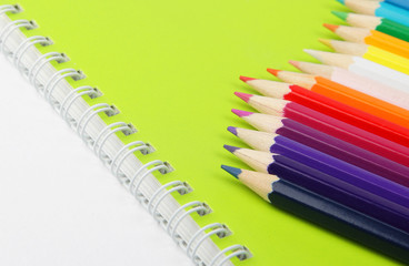 Color pencils on green notebook