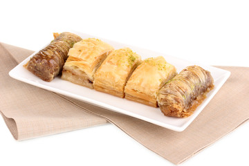 Sweet baklava on plate isolated on white