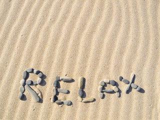 Fototapeta na wymiar Word relax written in sand