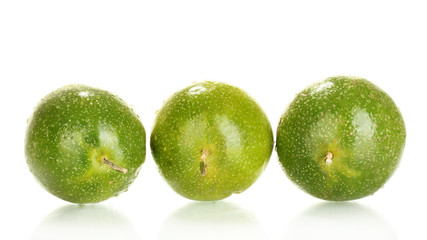 three green passion fruit isolated on white