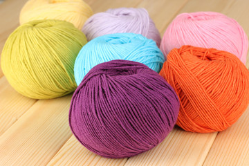 Knitting yarn on wooden background