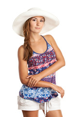 Pretty young girl in summer clothing and wearing a hat