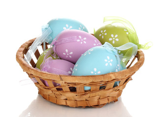 Colorful easter eggs in basket isolated on white