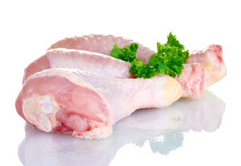 Raw Chicken Drumsticks in plate with parsley isolated on white