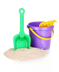 Children's beach toys and sand isolated on white