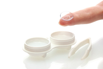 contact lenses in containers and tweezers, isolted on white