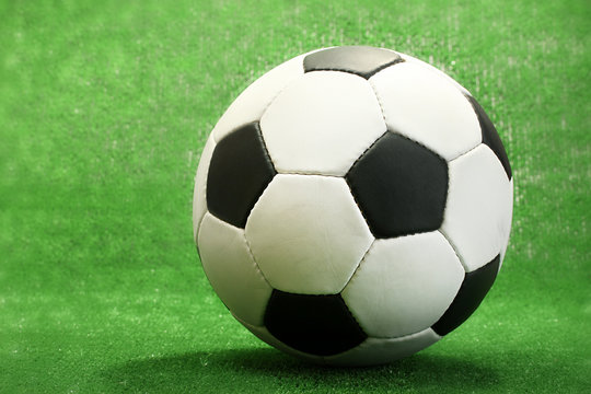 football ball on artificial green grass