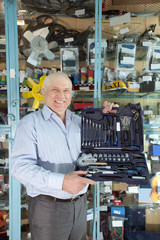 man holds  automotive  correction tool set