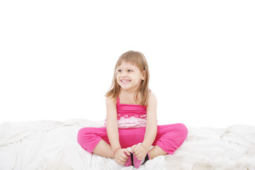 Obraz na płótnie Canvas Portrait of a cute little girl sitting on floor, isolated over w