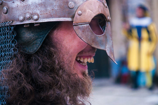 Portreit of a medival bierded laughing soldier with crooked teet