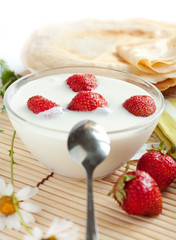 Yogurt with strawberries and flavored pancakes