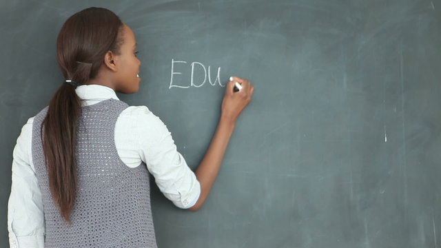 Video of a teacher looking at the blackboard
