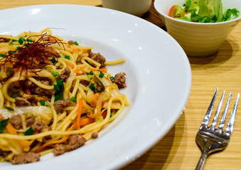 Spagetti with kimchi mixed minced meat beef and Japanese salad.