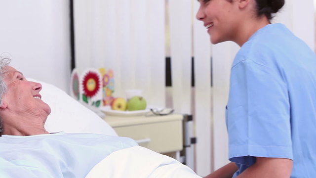 Nurse holding the hand of a senior patient