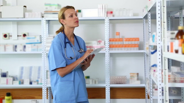 Blonde pharmacist holding a clipboard