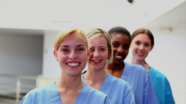 Smiling female nurses looking at camera