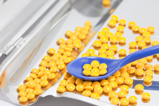 yellow pills in drug counting tray