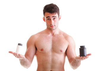Fototapeta premium holding a boxes with supplements on his biceps