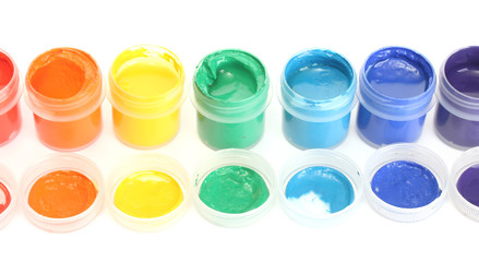 jars with multicolored gouache on white background