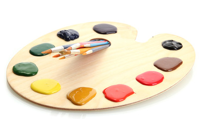 wooden art palette with  paint and brushes.isolated on white