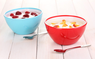 Yogurt with peaches and raspberries in bowls