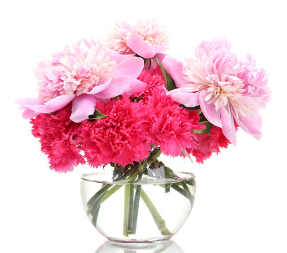 Bouquet of carnations and peonies in glass vase isolated