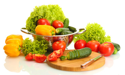 fresh vegetables and knife on cutting board isolated on white
