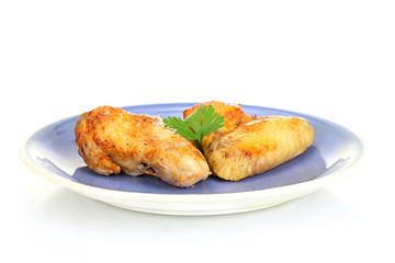 roasted chicken wings with parsley in the plate isolated