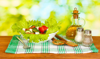 tasty greek salad on bright green background