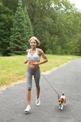 Woman is jogging with dog Jack Russel terrier