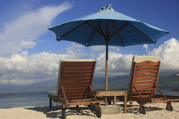 Sun chairs and umbrella on a beach