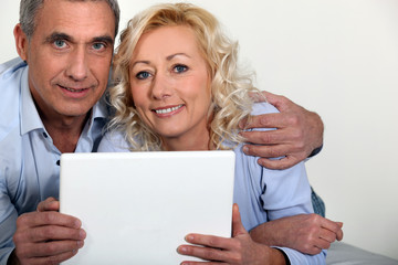 Middle-aged couple with computer