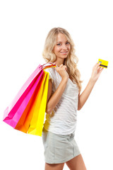 blonde woman holding card and bags