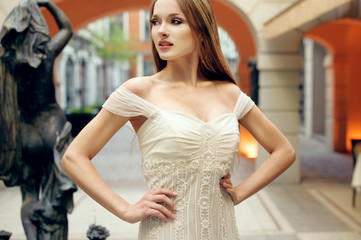 beautiful young woman posing on the street showing dresses