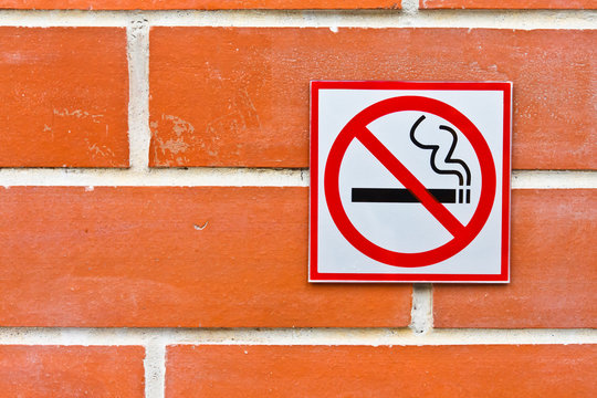 No Smoking Sign On Brick Wall