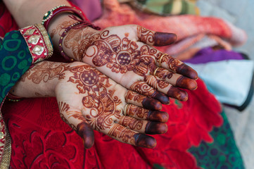 An Indian woman with henna tattoos on the hands, India