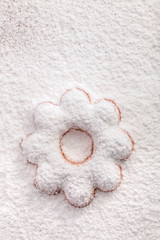 Cookies in the shape of a flower covered powdered sugar, (backgr