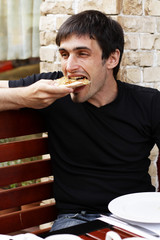 Guy is eating pizza with an appetite