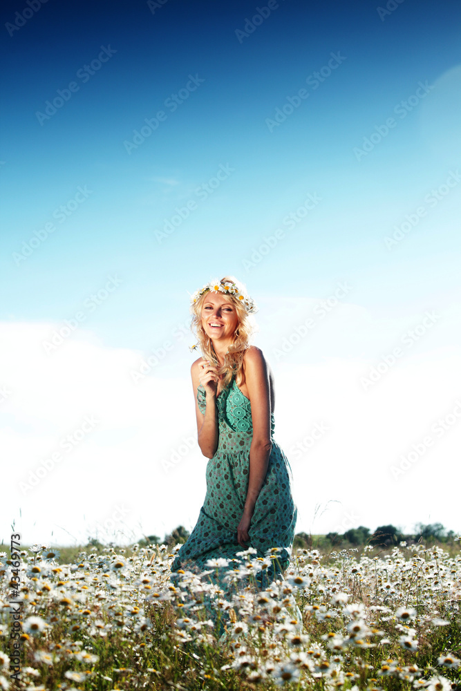 Wall mural girl in dress on the daisy flowers field