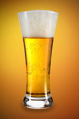 Beer in a glass with gold background
