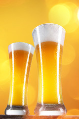 Beer in a glasses with gold background